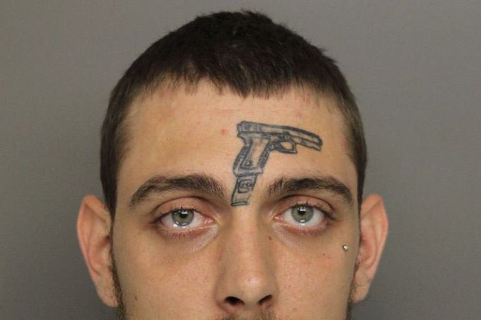 Man with gun tattoo on his FOREHEAD charged with possession firearm