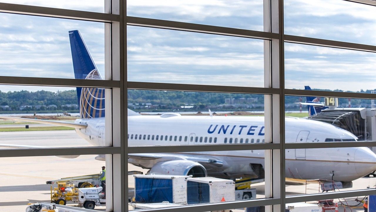 Passengers evacuate United Express flight via emergency slide after smoke detected in cabin