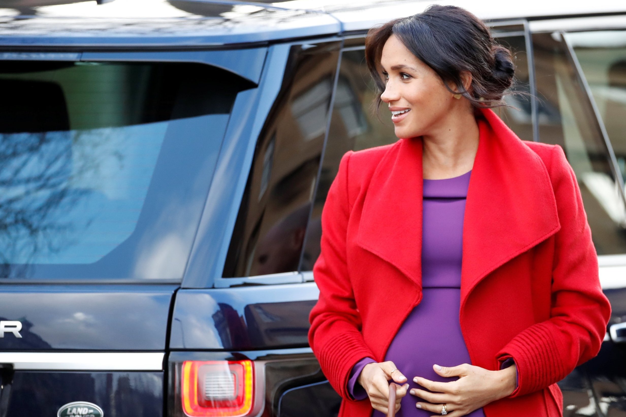 Meghan Markle dons regal red and purple on royal visit to Birkenhead