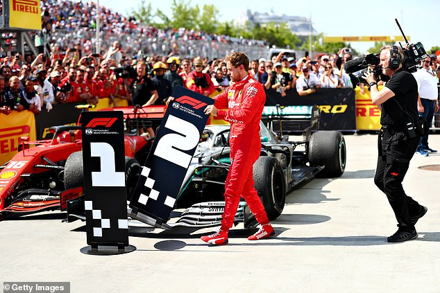 Sebastian Vettel moves No 1 bollard away from Lewis Hamilton’s Mercedes car