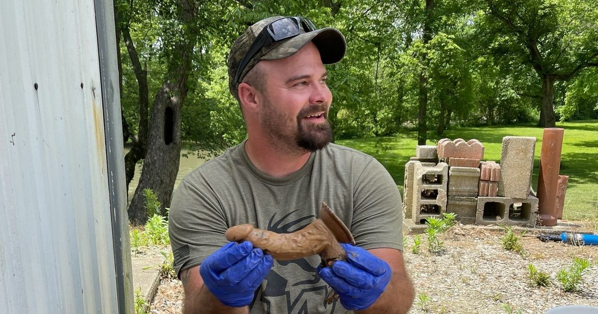 Proud fishermen catches first catfish only to find gigantic sex toy inside