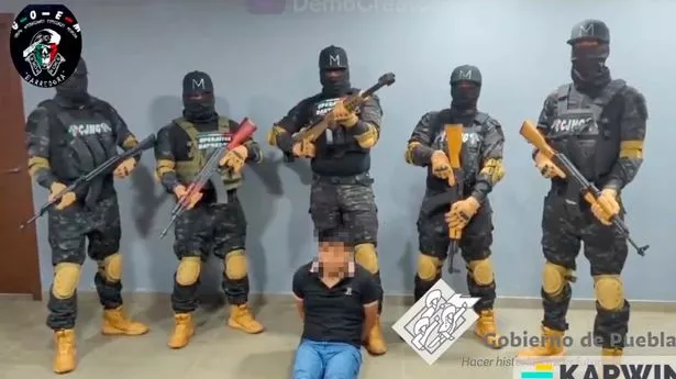 Masked cartel gunmen in chilling hostage video threatening to kill 'scumbags and clowns'