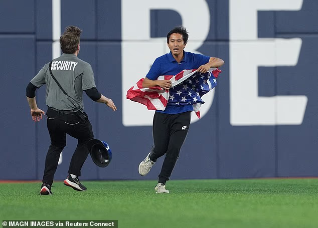 World Series fan with American flag invades field in Toronto before getting brutally tackled by security