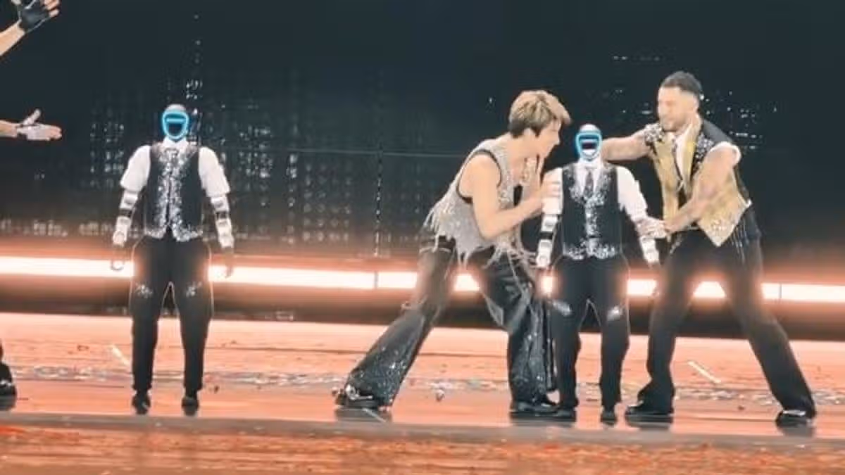 Glitching robot dancer falls over and hits popstar during concert malfunction